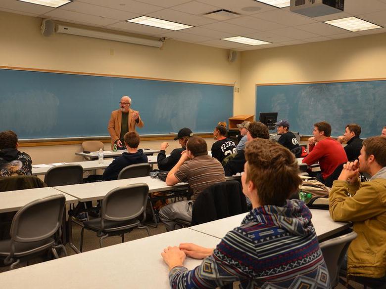 Professor Bill White teaching a course in a classroom