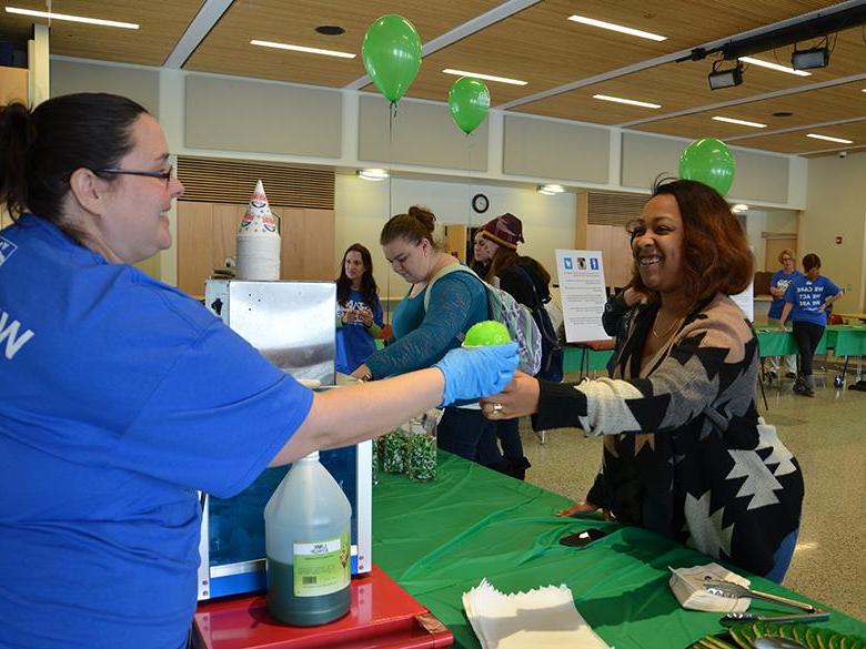 Maria Mosley serving treats at an event on campus